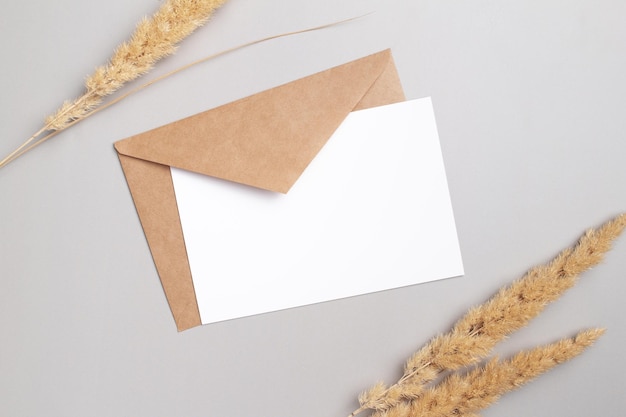 Mockup invitation blank greeting card and pampas grass Flat lay top view