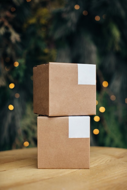 Mockup Kraft paper boxes with white stickers on Christmas background