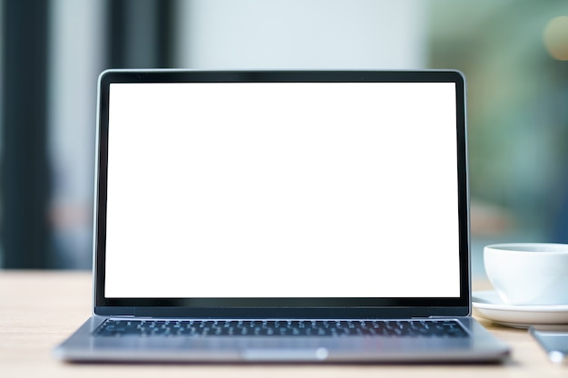 Mockup of laptop computer with empty screen with coffee cup and smartphone on table of the coffee shop background,White screen