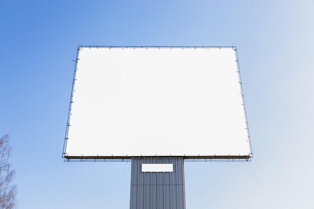 Mockup large white blank advertising billboard or promotion against the blue sky background