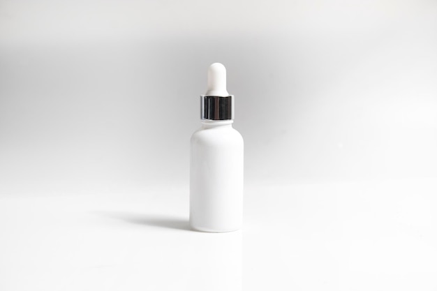 Mockup of medical skin care bottle cosmetic serum dropper beauty makeup facial treatment cleanser face