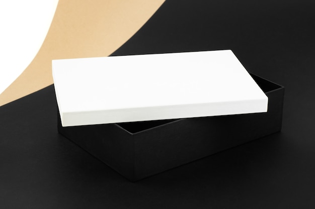 Mockup in the minimalist style of a large black box with a white lid