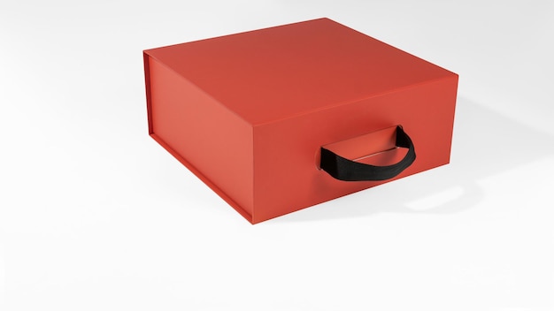 Mockup of a red box with a handle in volume for design