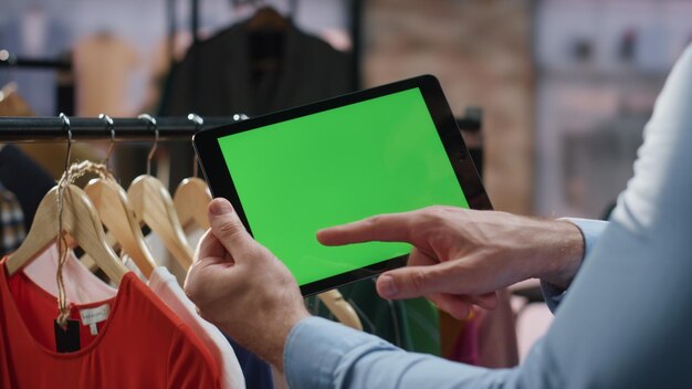 Photo mockup shop worker tapping tablet screen analysing shipment details closeup