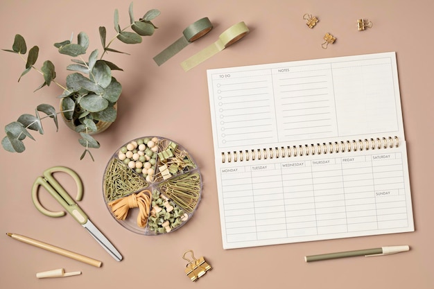 Mockup of weekly planner and coffee cup on beige background