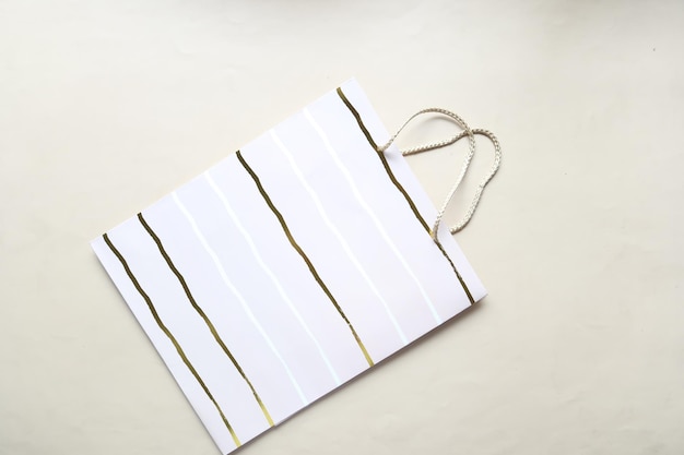 Mockup of white shopping bag on light color background