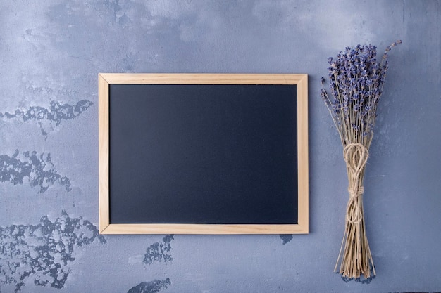 Mockup wooden blackboard with lavender flowers Top view text space