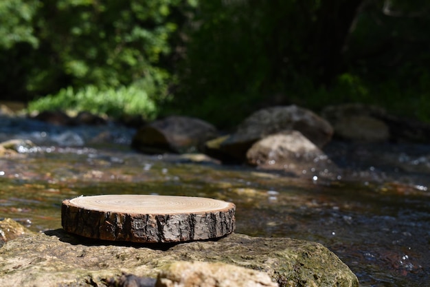 A mockup of a wooden podium on a blurred background of a mountain river