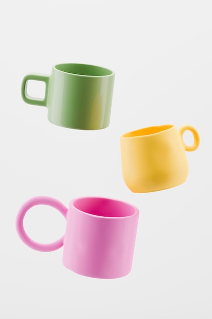 Mockups of three multicolored handmade clay flying cups on white background