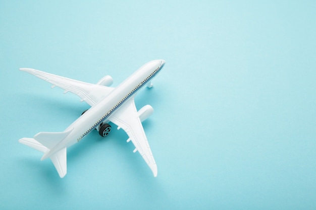 Model airplane on blue pastel color background. Travel concept