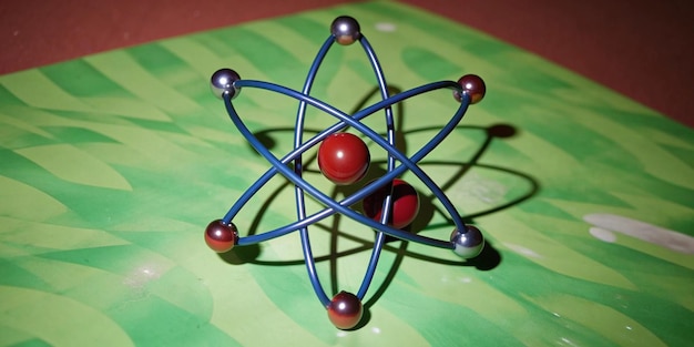 Photo a model of a atom with a blue and red ball on the top