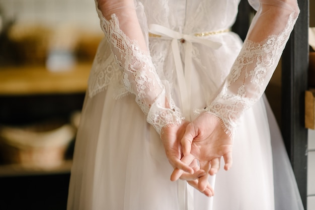 Model brunette in short hair posing in a white wedding dress