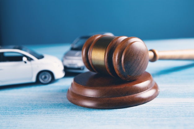 Model of car and gavel accident lawsuit or insurance