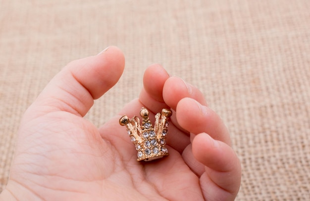 Model crown with pearls in hand