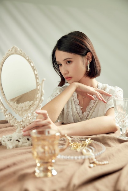 Model demonstrating earrings, pearl necklace and ring