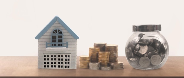 Model of detached miniature house mock and coins