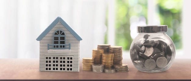 Model of detached miniature house mock and coins