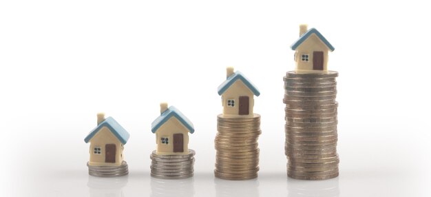 Photo model of detached miniature house mock up on coins. property real estate investment concept