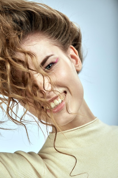 Model fooling around with hair posing on camera