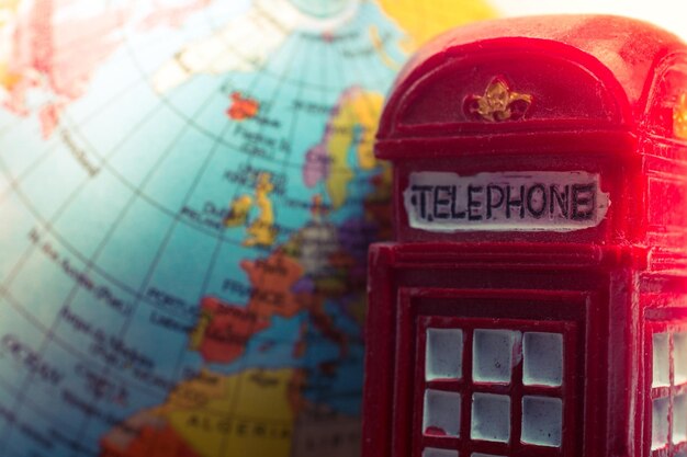 Model globe with a retro London telephone booth in view