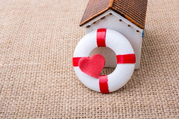 Model house and a life preserver with heart shaped