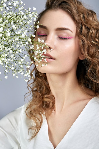 A model poses with a gypsophila branch