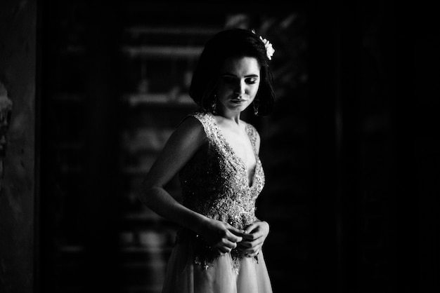 Model posing in a white long wedding dress indoors