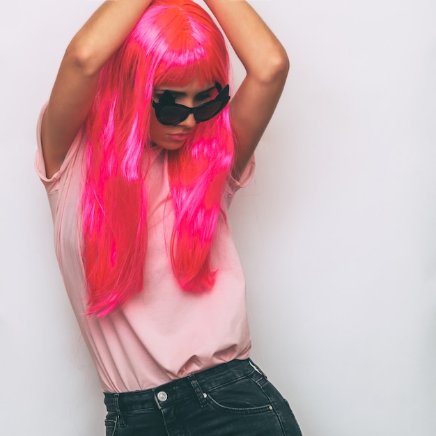 Model in stylish accessories with pink hair.