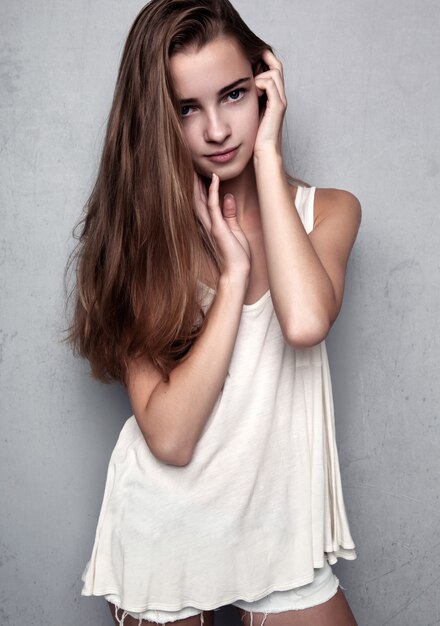 Photo model test with young beautiful fashion model wearing white t-shirt in studio.color portrait