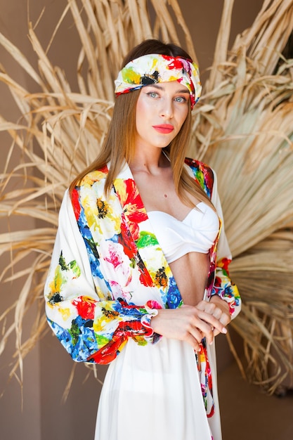 A model wears a flowered scarf with a scarf on it.