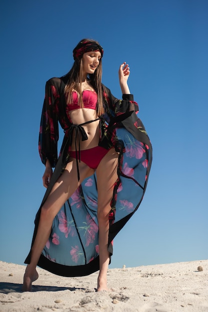 A model wears a kimono with a flower print on it.