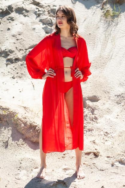 A model wears a red bikini top and a hat.