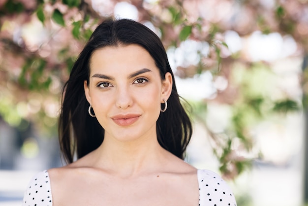 model with creative vivid makeup and pink lipstick on lips and hairstyle posing outside