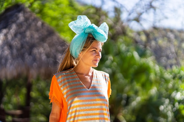 Model with a headband and exotic dress outdoors