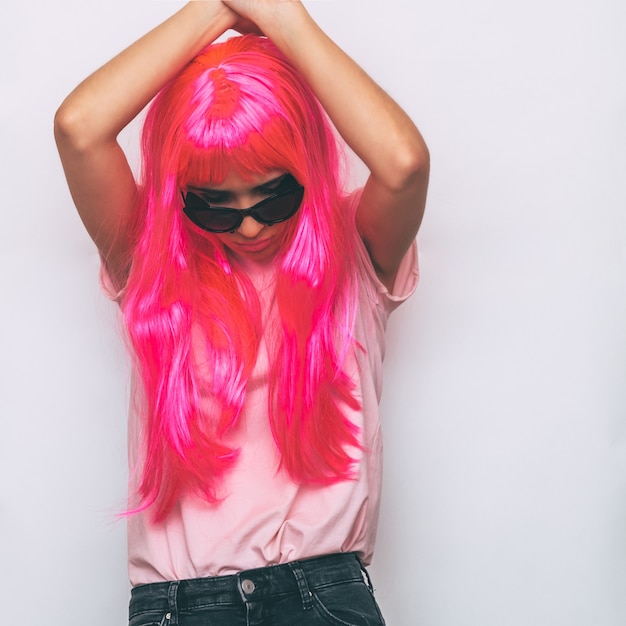 Model with pink wig and stylish accessories.