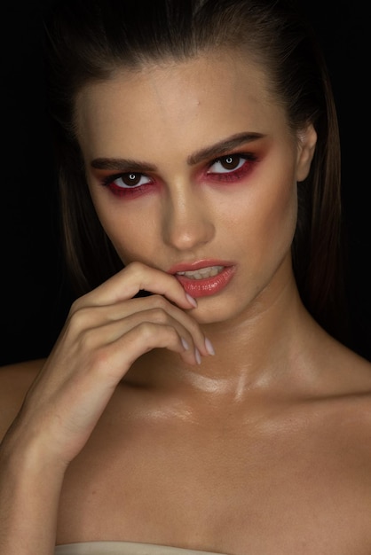 A model with red eyes and red lipstick