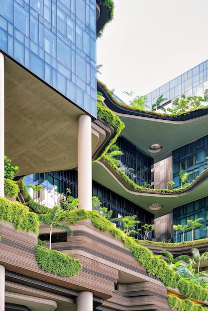 Modern architecture of a balcony of the building with much green plants. Modern design in the center of Singapore.