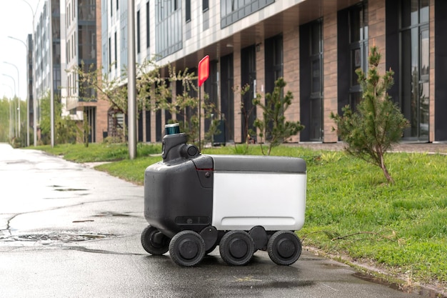 Photo modern automated delivery robot stands outside waiting for an order in rainy weather