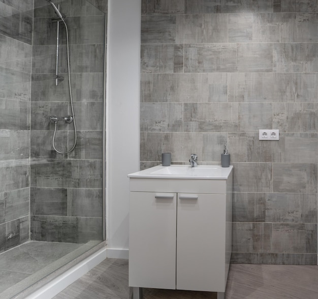 Modern bathroom interior with tiled walls