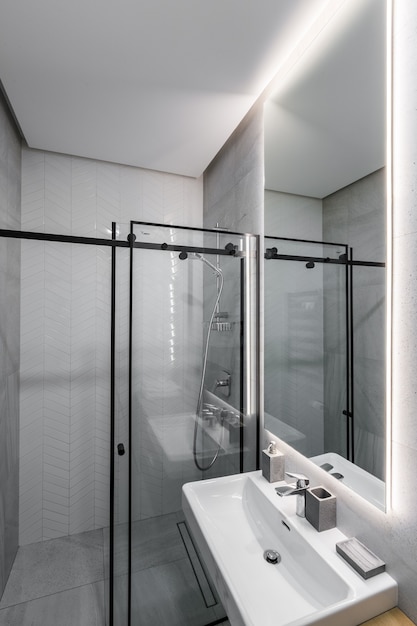  modern bathroom with shower in a small apartment with white marble tiles