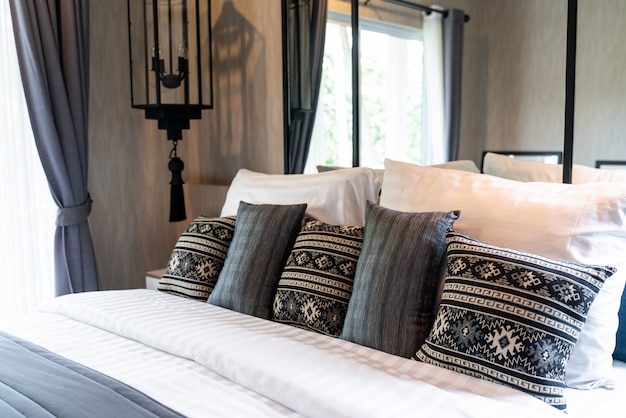 Modern bedroom with many pillows on bed