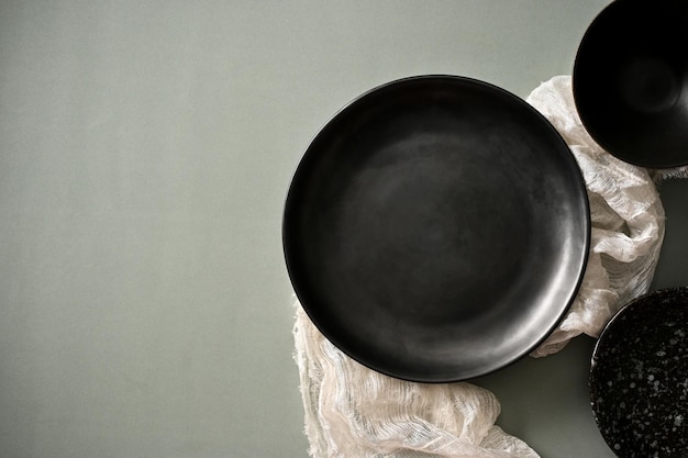 Modern black ceramic plates and copy space on grey table