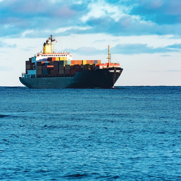 Modern black container ship moving from Baltic sea