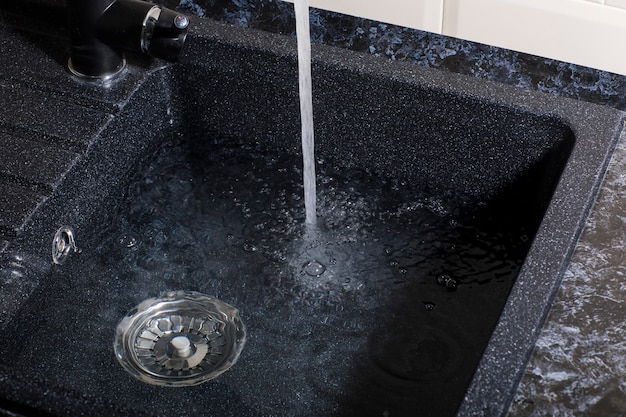 Photo modern black kitchen sink with faucet