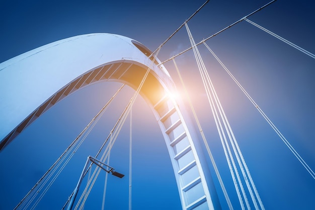 Modern Bridge Architecture Against Blue Sky with Sunflare