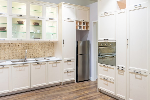 Modern, bright, clean kitchen interior with stainless steel appliances in a luxury apartment.