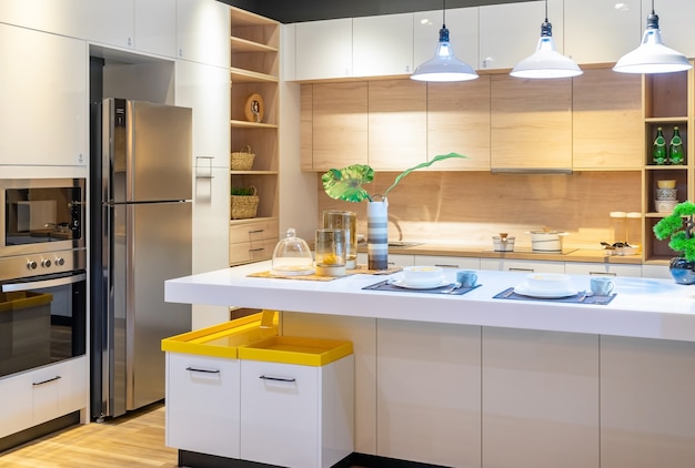 Modern, bright, clean kitchen interior with stainless steel appliances in a luxury apartment.