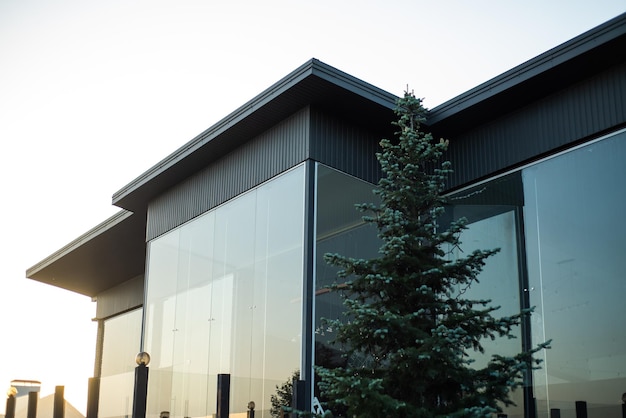 Modern building facade on village on the sunset