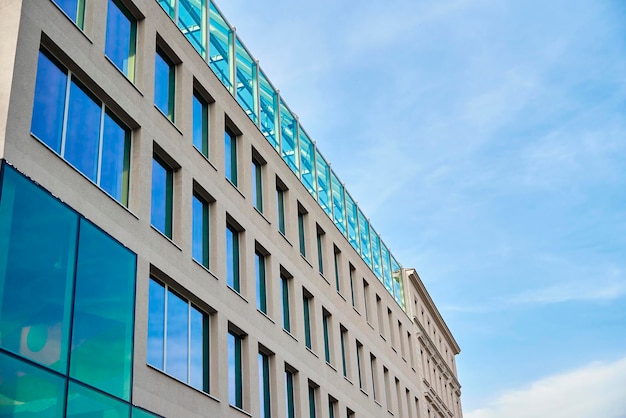 Modern building facade with windows against blue sky