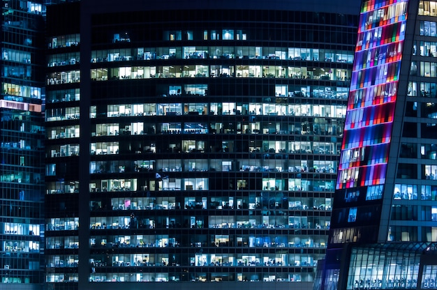 Modern building with light in windows at night